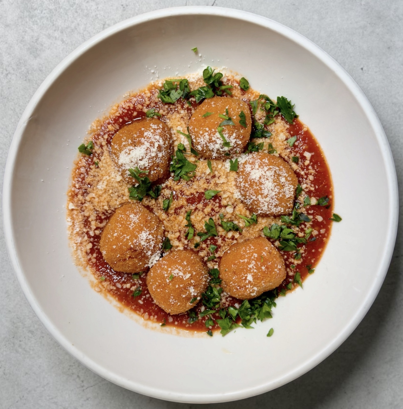 Sicilian arancini in marinara sauce