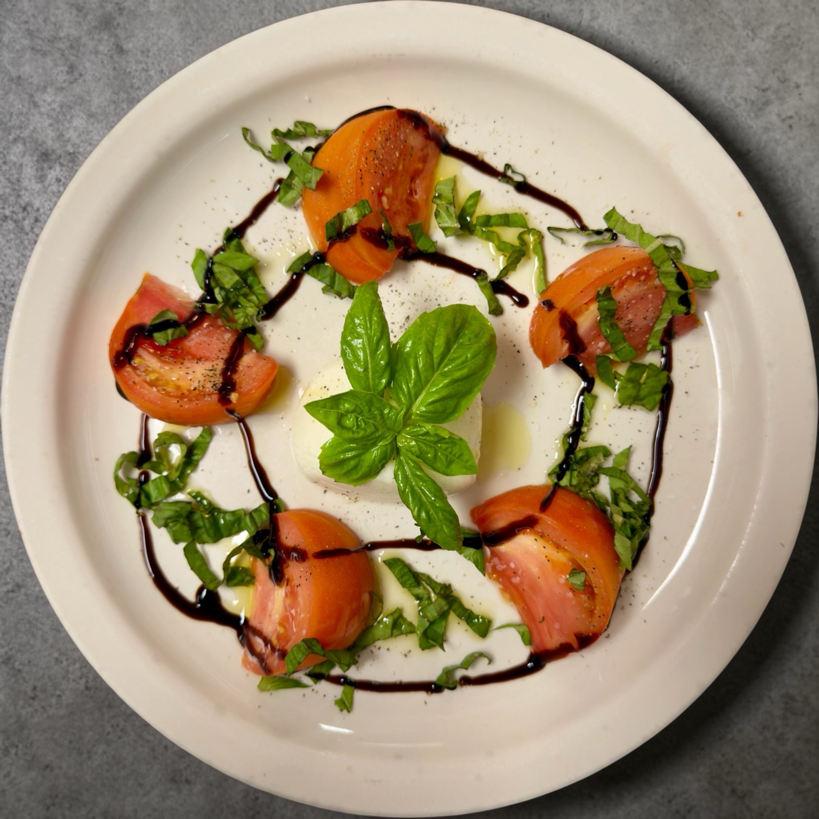 Caprese salad with burrata, fresh tomatoes, and basil