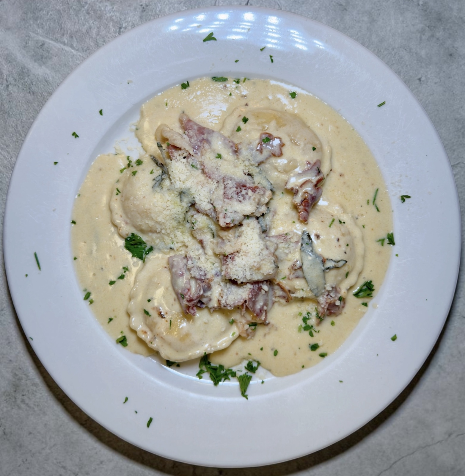 Cheese ravioli in creamy sage sauce with prosciutto