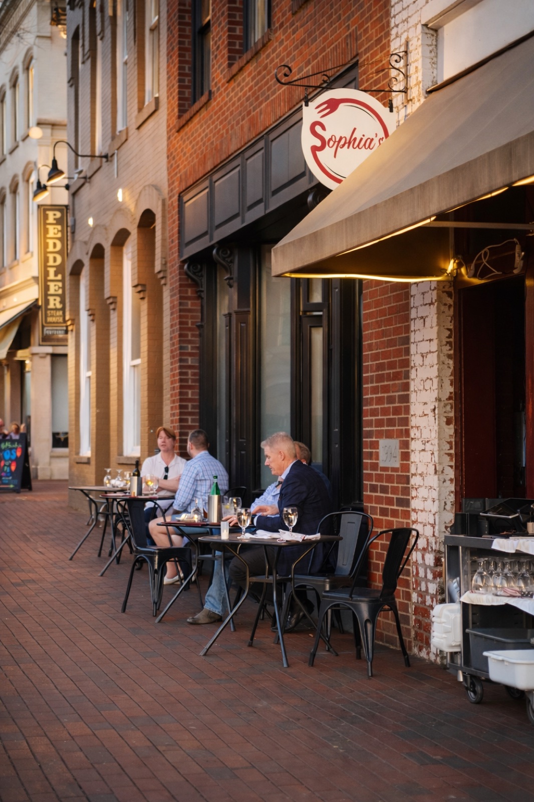 Diners on Sophia's outdoor patio at sunset