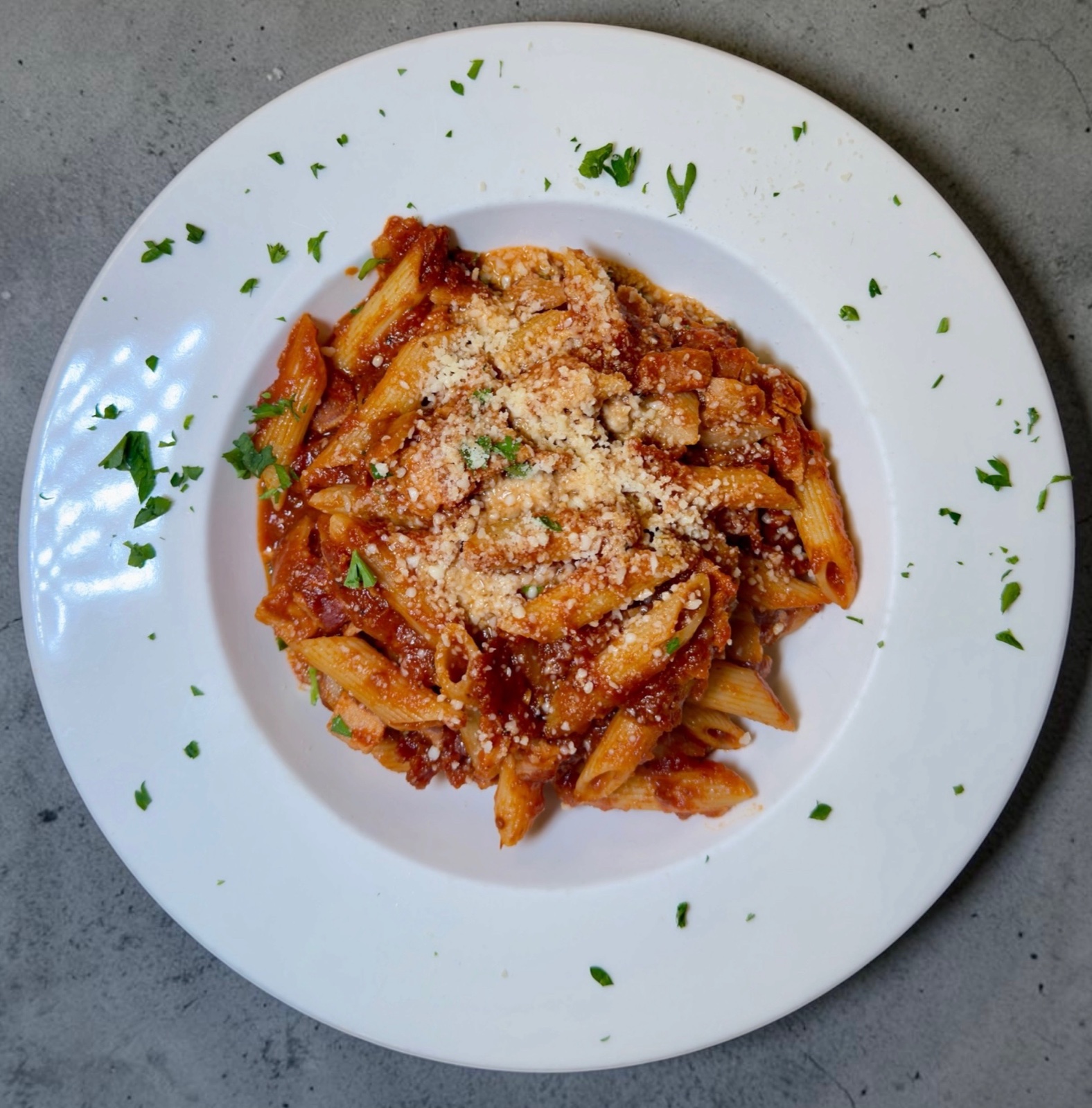 Penne all'Amatriciana with bacon, onions, and marinara sauce