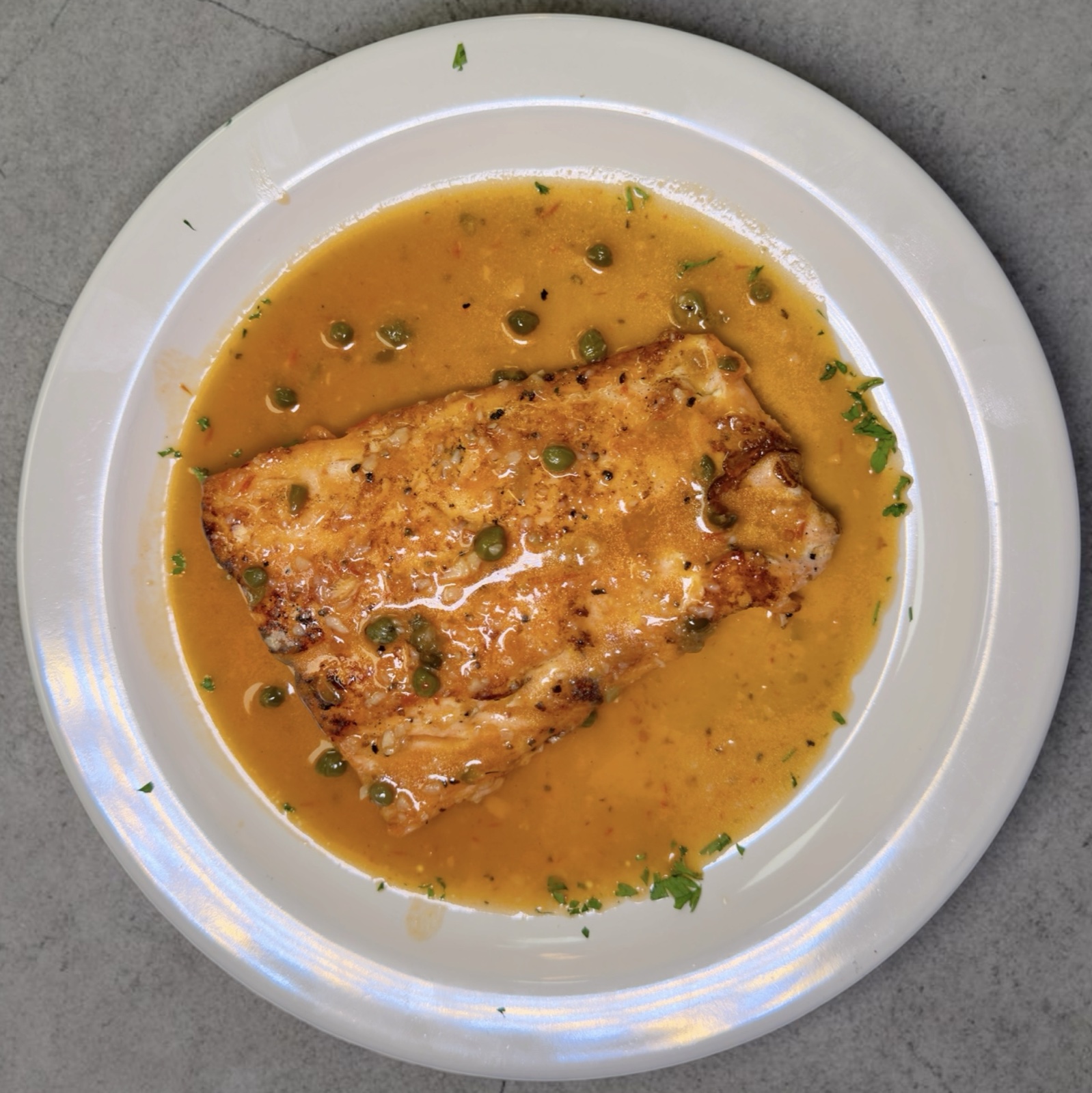 Pan-seared salmon in lemon capers sauce