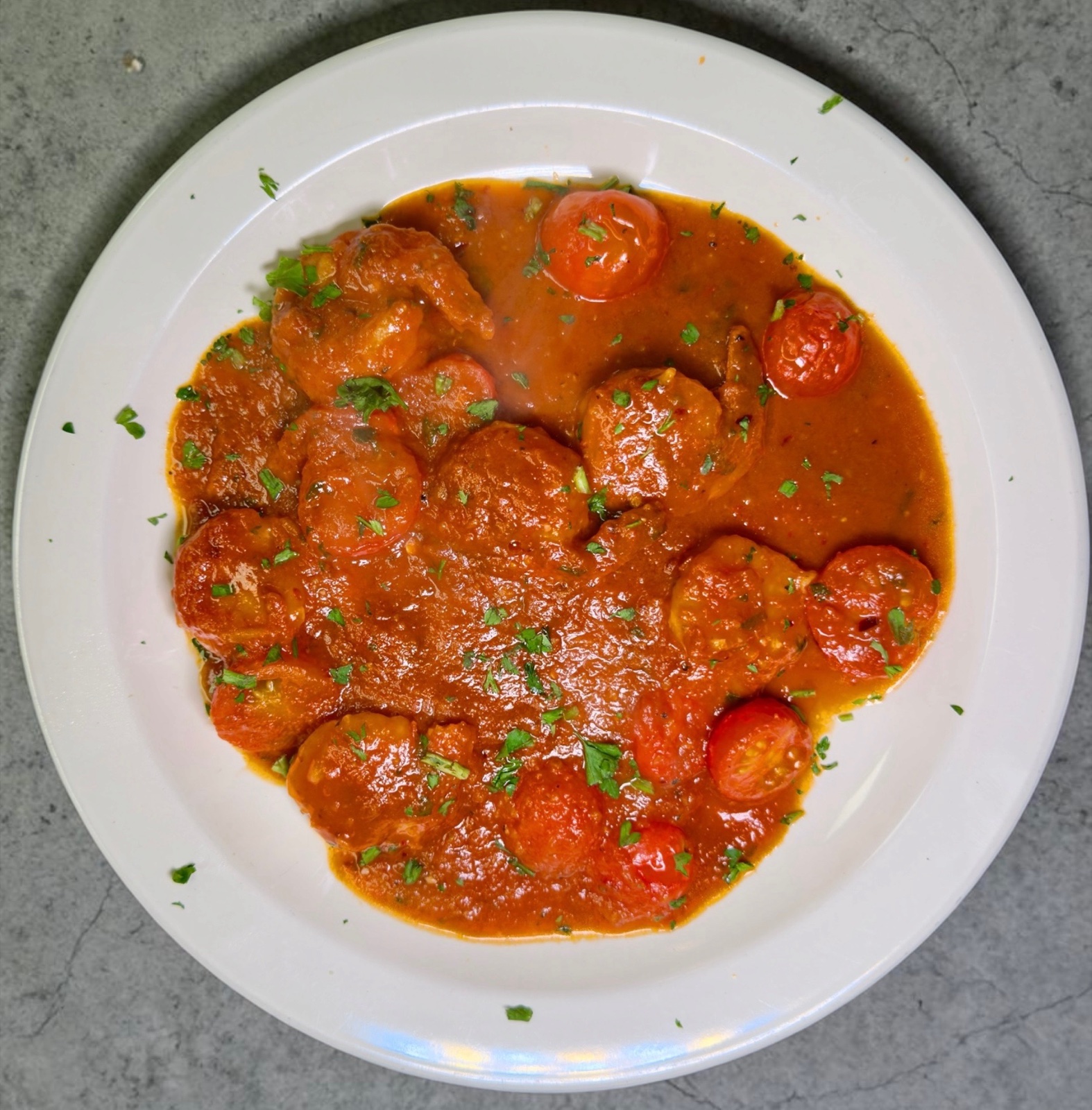 Shrimp Fra Diavolo in spicy red garlic sauce with cherry tomatoes